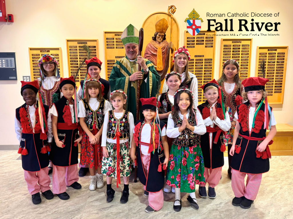 Diocese of Fall River Bishop da Cunha with children following the 125th anniversary Mass of St. Stanislaus parish.